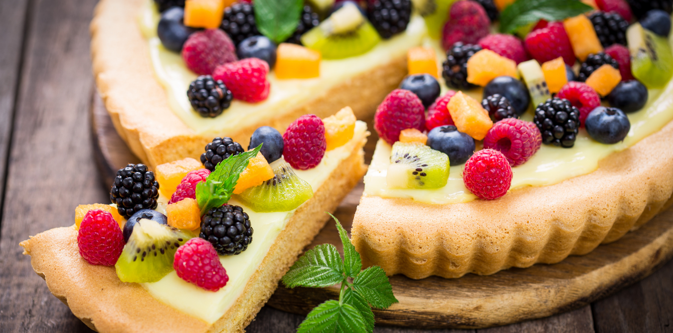 Seasonal fruit tart topped with vanilla pastry cream, raspberries, blackberries, blueberries, kiwi and other fresh fruit.